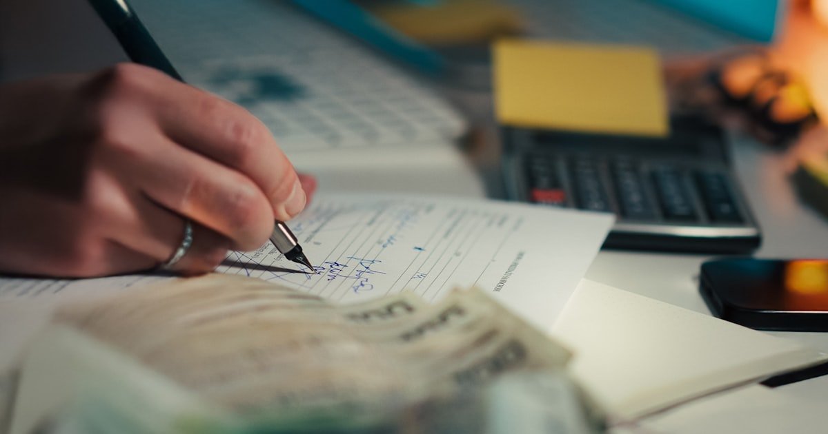 Photo representing a budgeting spreadsheet and phone app side by side